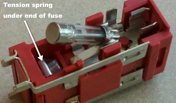 fuse block with fuse pulled up to show metal spring as described