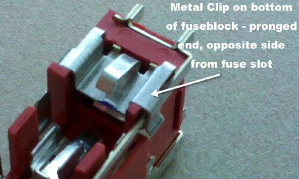 bottom of fuse block with metal clip labelled